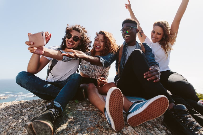 Friends Sitting on Top of a Mountain 